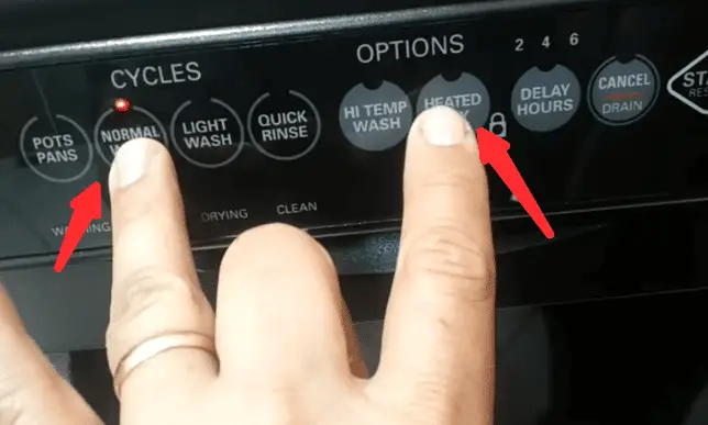 Pointing to the buttons on the cover of kenmore elite dishwasher