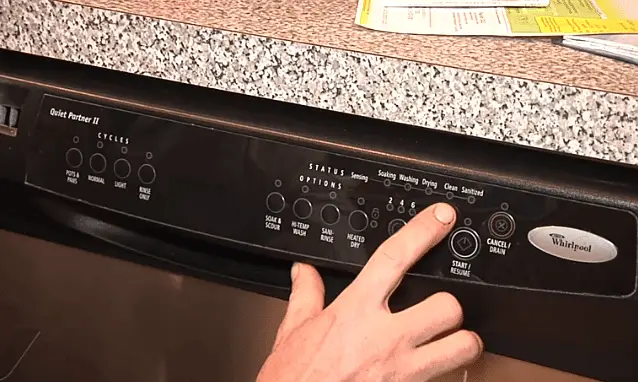 touching a button on whirlpool dishwasher